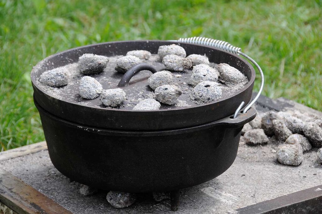 dutch_oven_stove_in_hard_with_coal_on_it