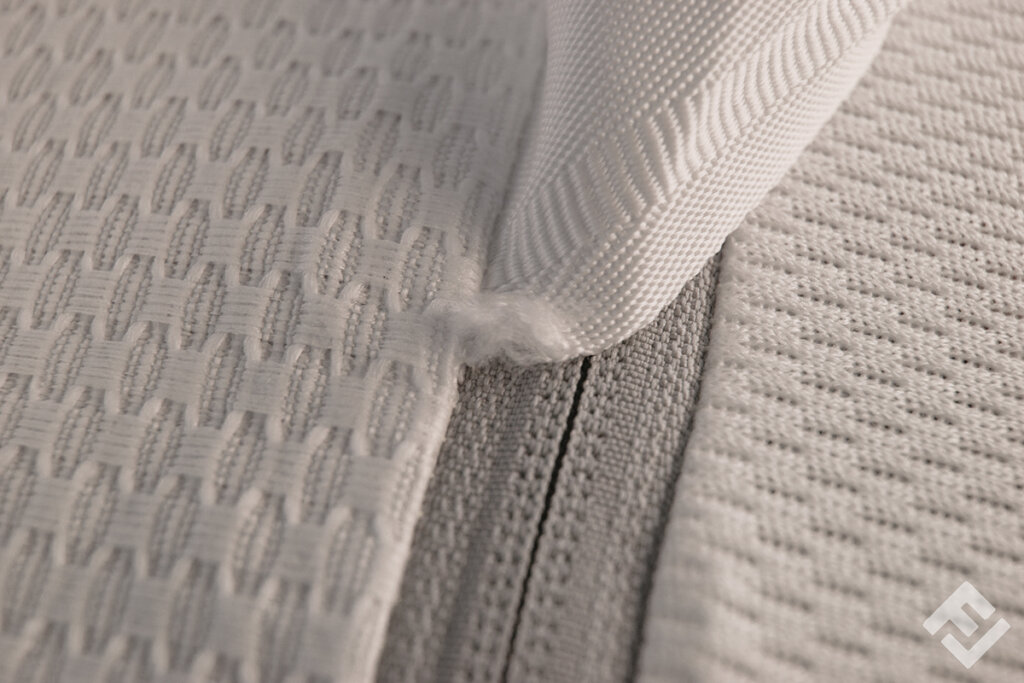 close up of zip with material defect