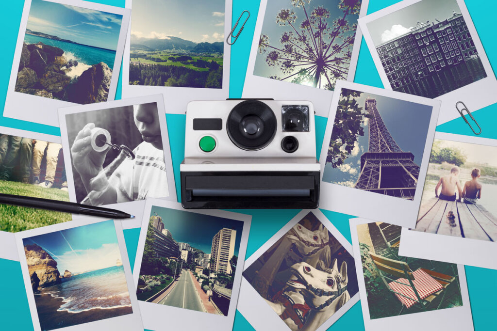 Un appareil photo instantané avec flash se trouve au centre de l'image. Sur le mur derrière se trouvent des images.v